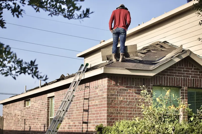 Professional roofer working on a residential roof in Old Mill Farms